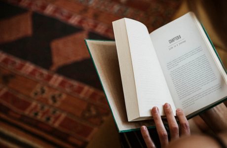 Woman reading a book in her living room