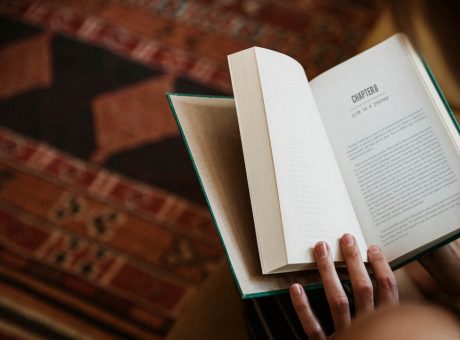 Woman reading a book in her living room